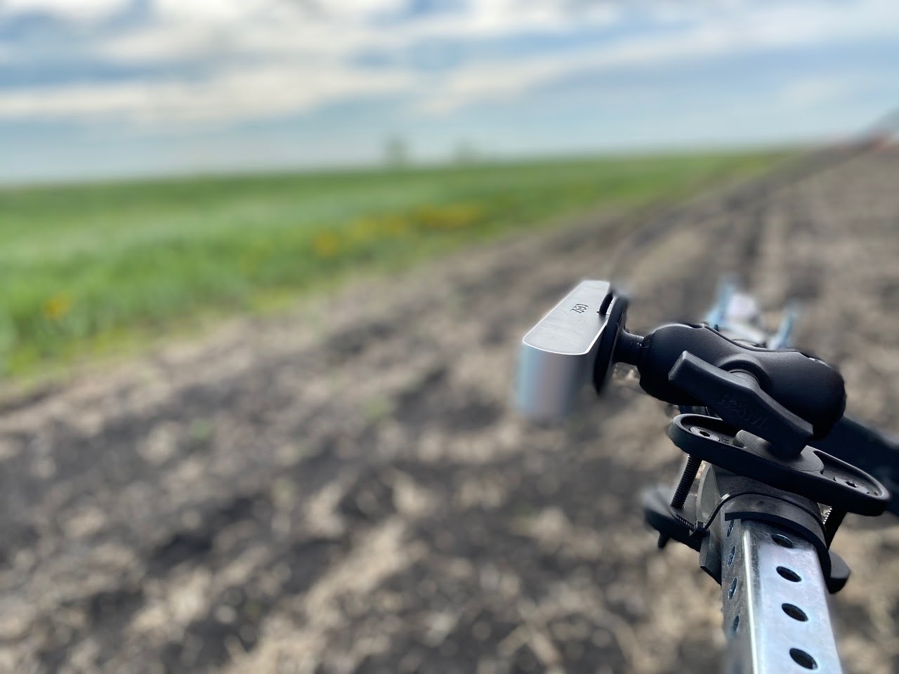 Photo of a robotic arm conducting tests in an agricultural field