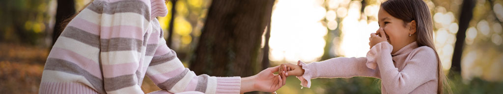 Close-up image of child and parent holding hands - Family Law Modernization website banner