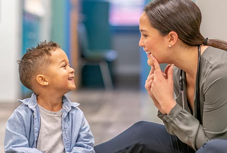 Speech-language pathologist working with child