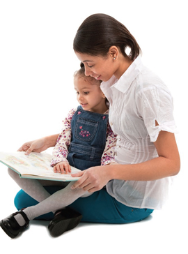 girl sitting on a woman's lap reading a book