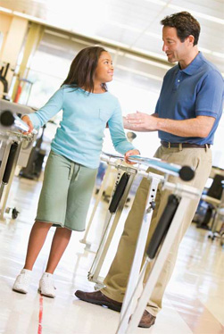 child walking between two bars looking up at a man talking with her